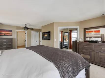 a bedroom with a large bed and a flat screen tv