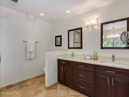 a bathroom with a double vanity sink and mirror