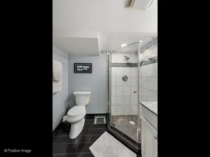 a bathroom with a toilet and a shower