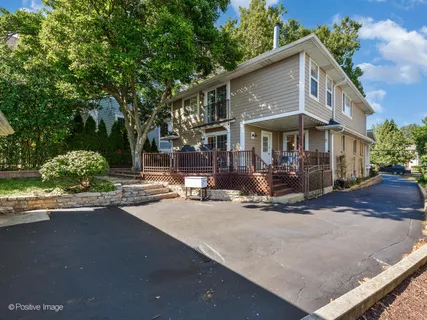 a front view of a house with porch and sitting area