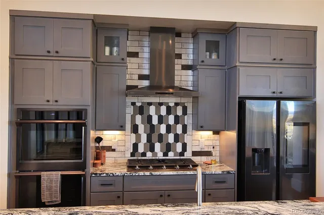 a kitchen with cabinets and stainless steel appliances