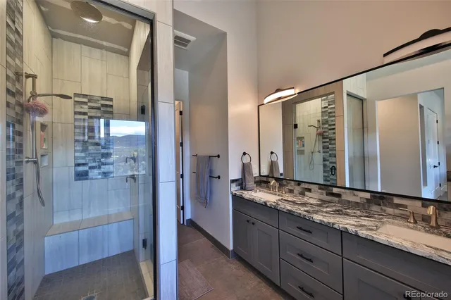 a bathroom with a granite countertop sink mirror and double