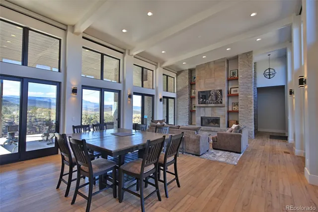 a dining room with furniture window and wooden floor