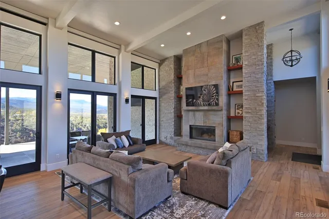 a living room with furniture wooden floor and a fireplace