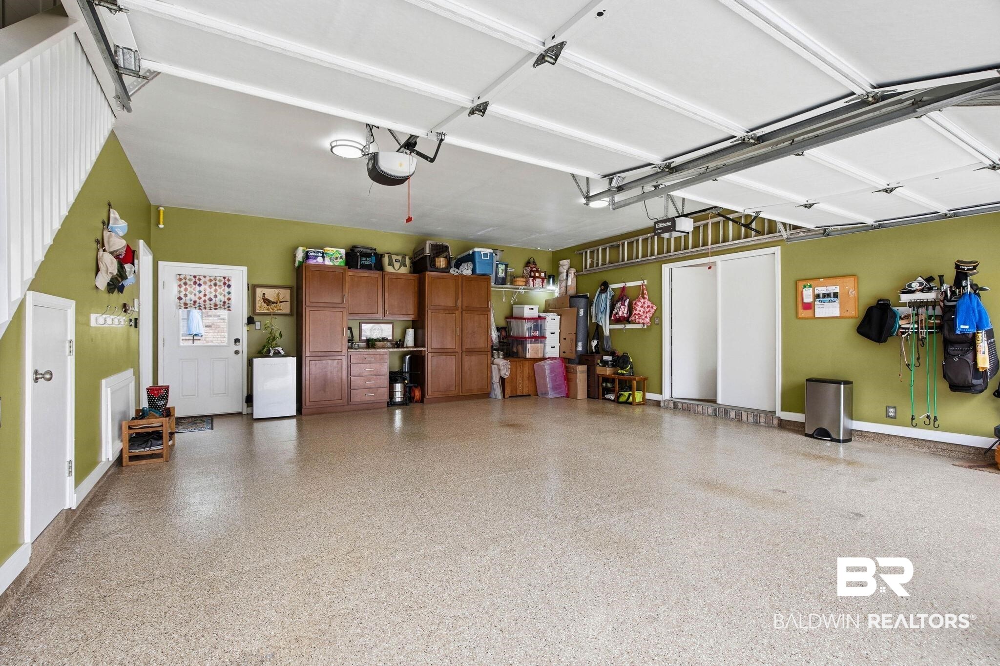 31515 Rhett Drive Spanish Fort, AL 36527 - Photo 64 of 100 Custom cabinets and epoxy floor. The garage fridge and EV port conveys with the home.