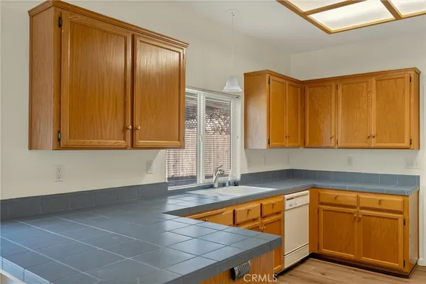 a kitchen with stainless steel appliances granite countertop a sink and cabinets