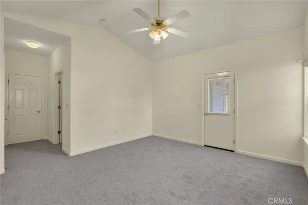 a view of a room with a ceiling fan and a chandelier fan