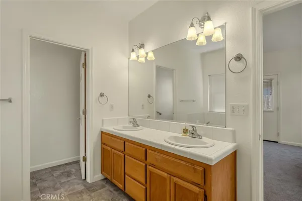 a bathroom with a sink a light fixture and a mirror