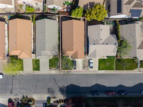 a aerial view of a house with a yard and potted plants