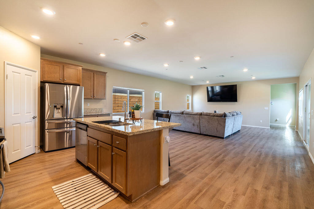 67470 Rio Naches Road Cathedral City, CA 92234 - Photo 1 of 32 a kitchen with stainless steel appliances kitchen island granite countertop a stove and a refrigerator