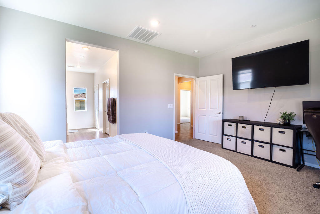 67470 Rio Naches Road Cathedral City, CA 92234 - Photo 13 of 32 a bedroom with a bed and a flat screen tv