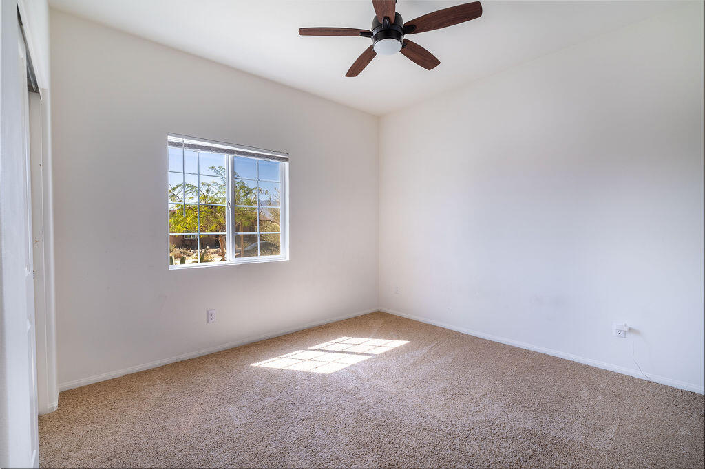 67470 Rio Naches Road Cathedral City, CA 92234 - Photo 16 of 32 an empty room with a window and a fan