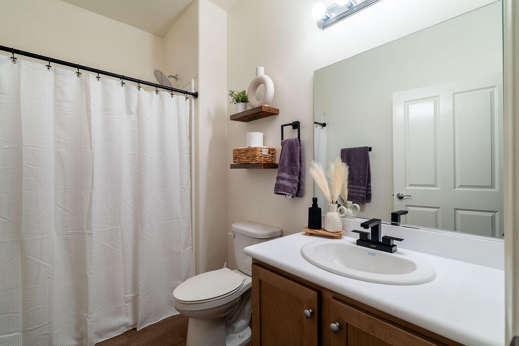 67470 Rio Naches Road Cathedral City, CA 92234 - Photo 18 of 32 a bathroom with a sink vanity mirror and toilet