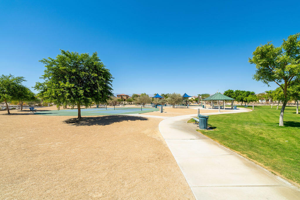 67470 Rio Naches Road Cathedral City, CA 92234 - Photo 30 of 32 a view of swimming pool with seating area and trees in the background