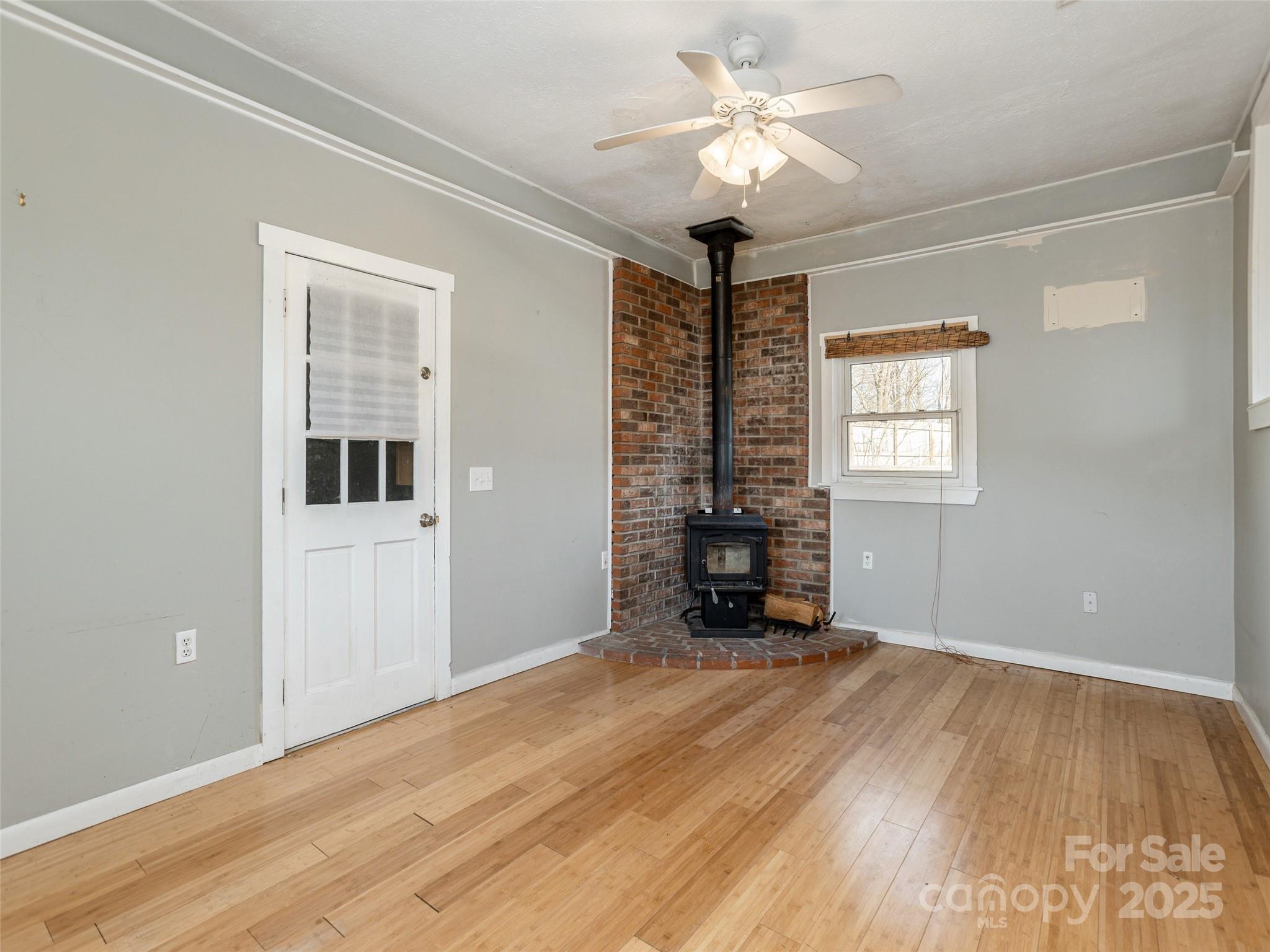 5057 Howard Gap Road Flat Rock, NC 28731 - Photo 9 of 19 a view of an empty room with a window and a kitchen