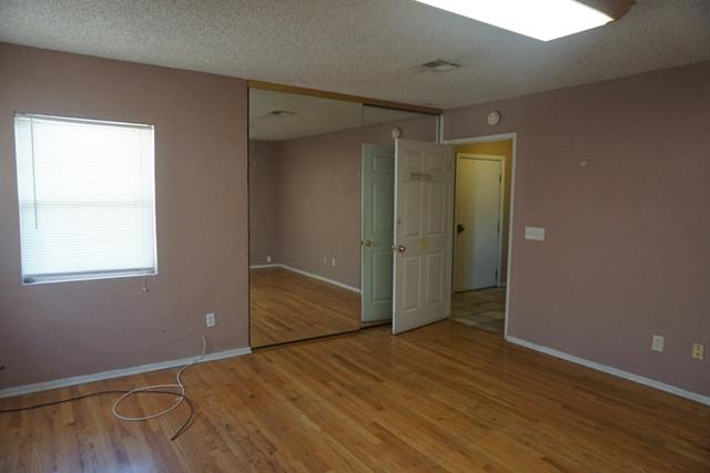 44822 Genoa Avenue Lancaster, CA 93534 - Photo 14 of 27 a view of an empty room with wooden floor and a window