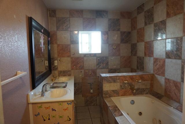 44822 Genoa Avenue Lancaster, CA 93534 - Photo 15 of 27 a bathroom with a sink toilet and shower