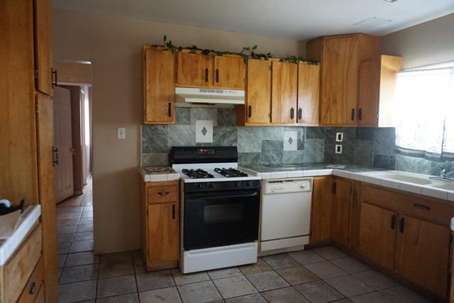 44822 Genoa Avenue Lancaster, CA 93534 - Photo 5 of 27 a kitchen with a sink stove and cabinets