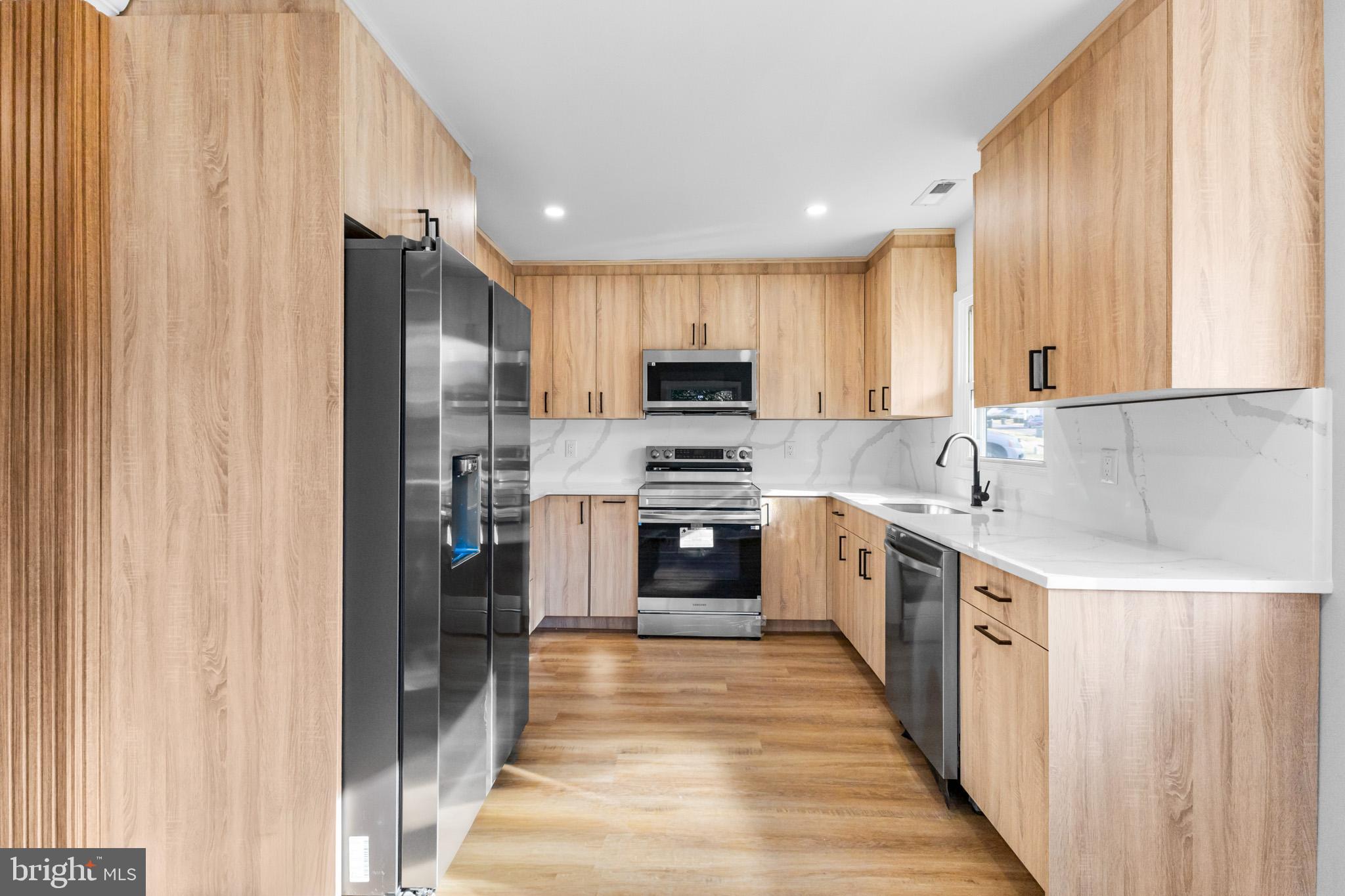 5 Perennial Lane Willingboro, NJ 08046 - Photo 16 of 52 a kitchen with stainless steel appliances granite countertop a refrigerator and a stove top oven