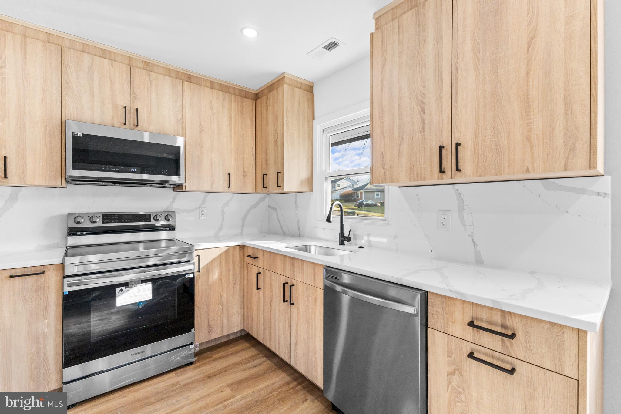 5 Perennial Lane Willingboro, NJ 08046 - Photo 17 of 52 a kitchen with a sink stove and microwave