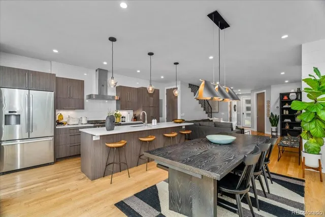 a kitchen with a table chairs and refrigerator