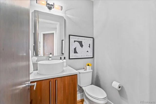 a bathroom with a sink a toilet and mirror