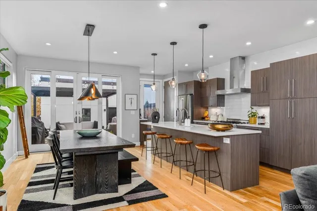 a open kitchen with stainless steel appliances granite countertop a stove and a refrigerator