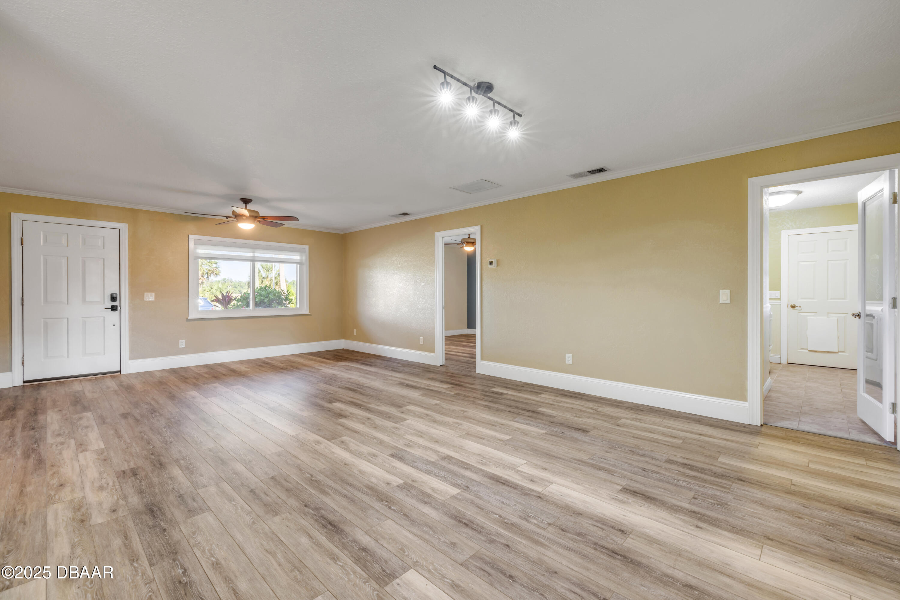 1617 Hontoon Road DeLand, FL 32720 - Photo 11 of 43 an empty room with wooden floor and windows