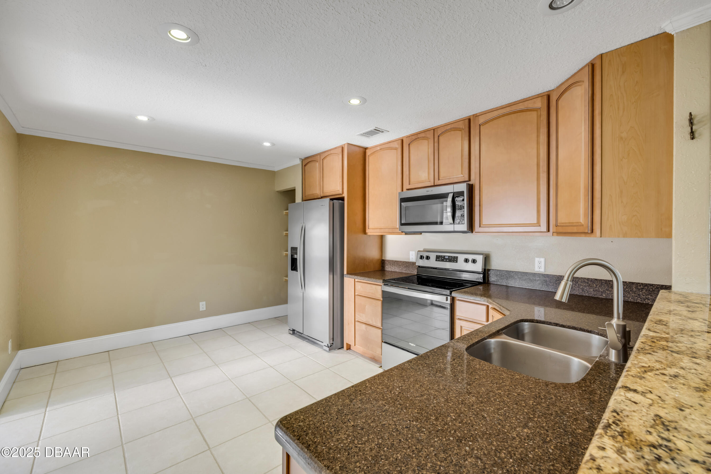 1617 Hontoon Road DeLand, FL 32720 - Photo 12 of 43 a kitchen with stainless steel appliances granite countertop a sink refrigerator and microwave