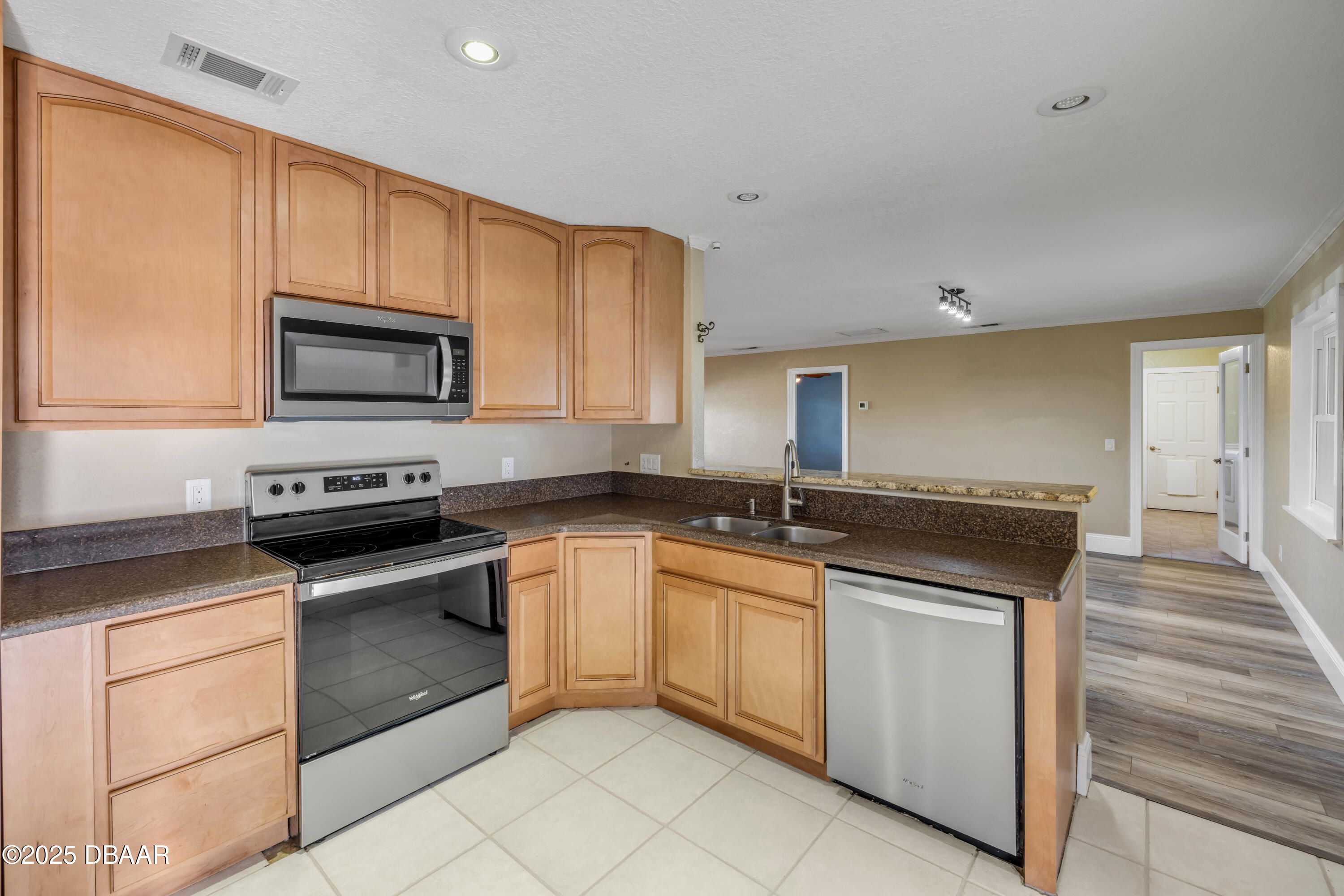 1617 Hontoon Road DeLand, FL 32720 - Photo 13 of 43 a kitchen with granite countertop a stove sink and microwave