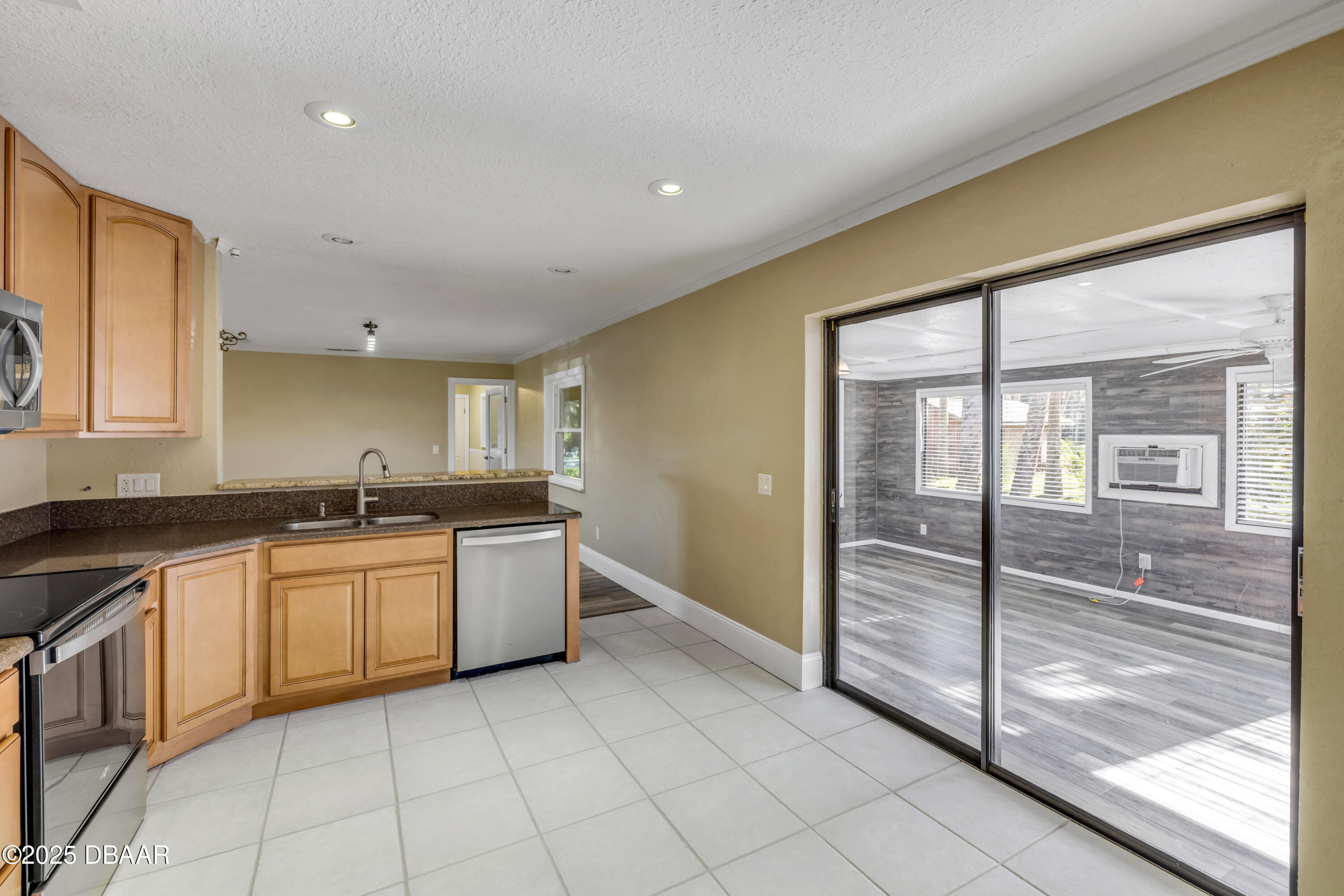 1617 Hontoon Road DeLand, FL 32720 - Photo 14 of 43 a large kitchen with a large window and stainless steel appliances