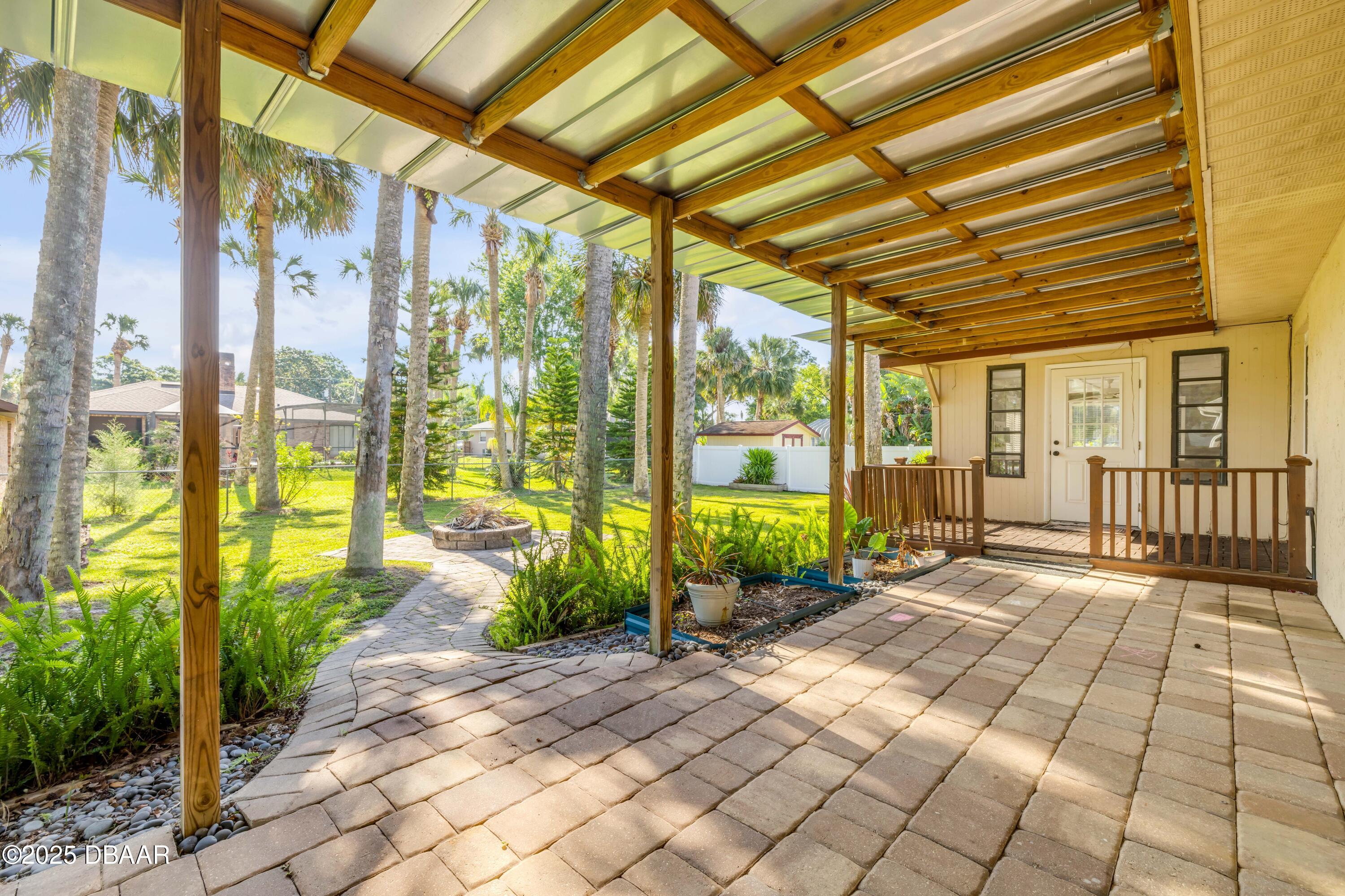 1617 Hontoon Road DeLand, FL 32720 - Photo 30 of 43 a view of a porch with wooden floor and iron stairs