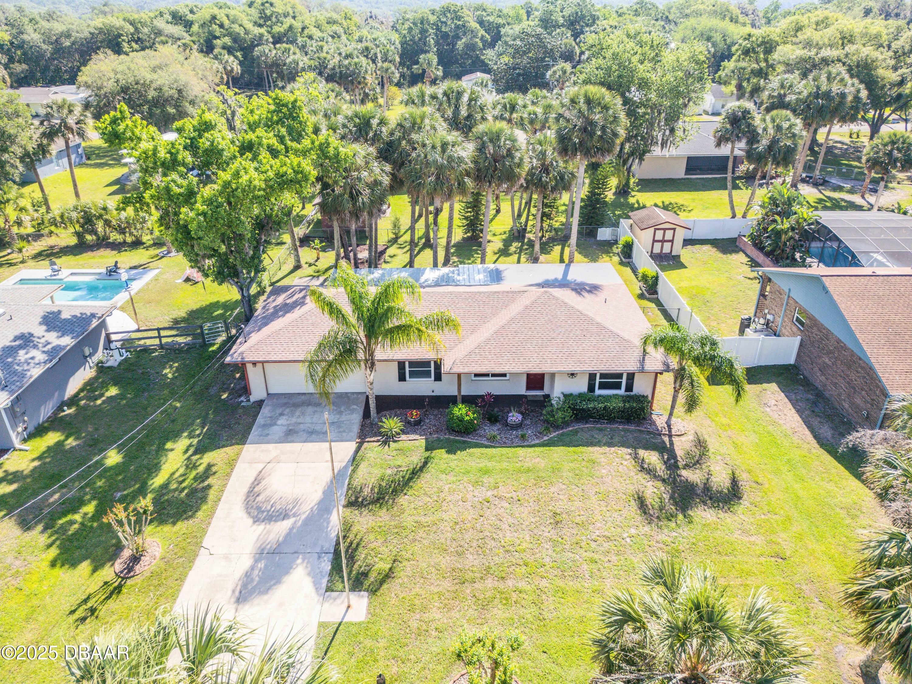 1617 Hontoon Road DeLand, FL 32720 - Photo 3 of 43 a view of swimming pool with outdoor seating and yard