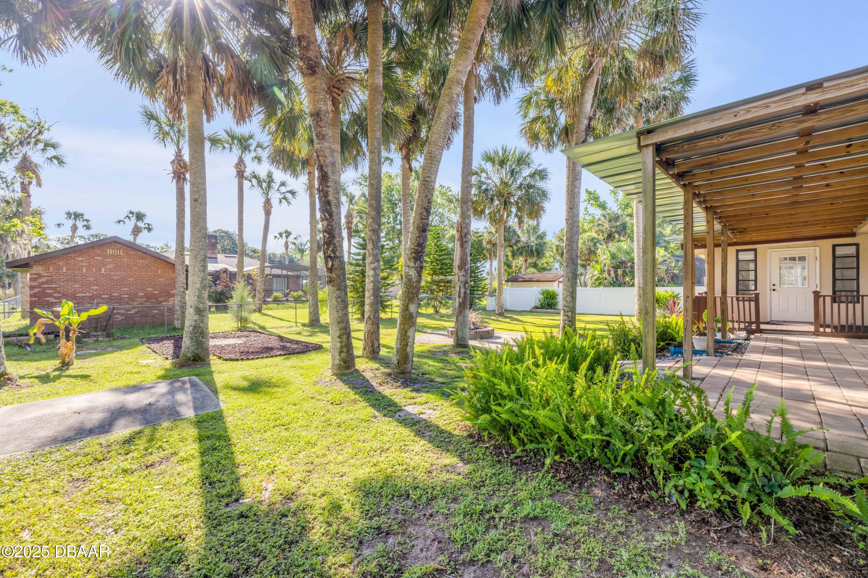 1617 Hontoon Road DeLand, FL 32720 - Photo 35 of 43 a view of a swimming pool with an outdoor seating