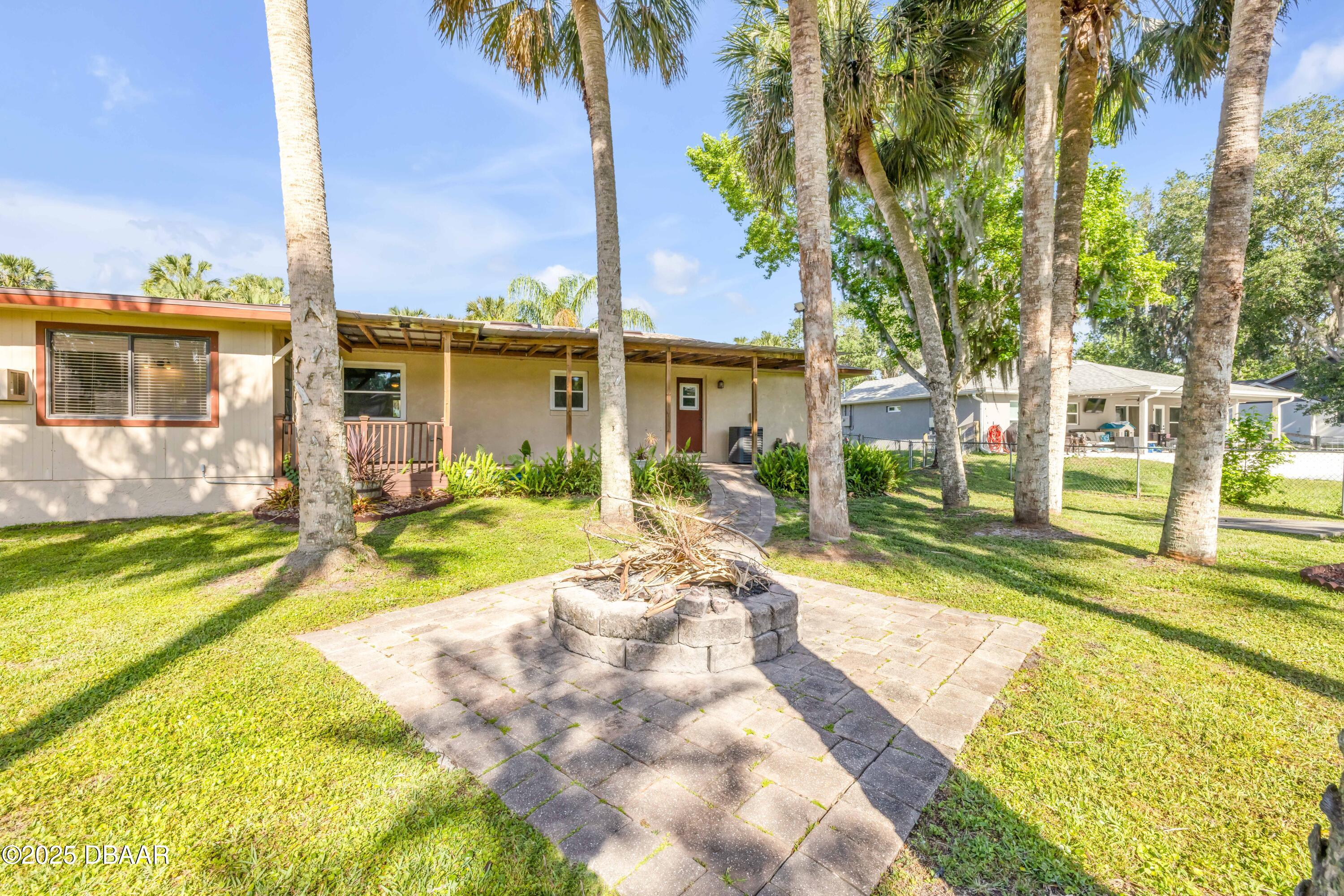 1617 Hontoon Road DeLand, FL 32720 - Photo 38 of 43 a view of a house with swimming pool next to a yard