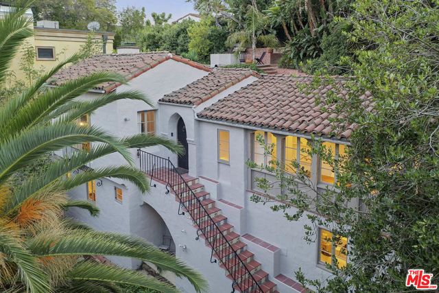 an aerial view of a house with a yard basket ball court and outdoor seating