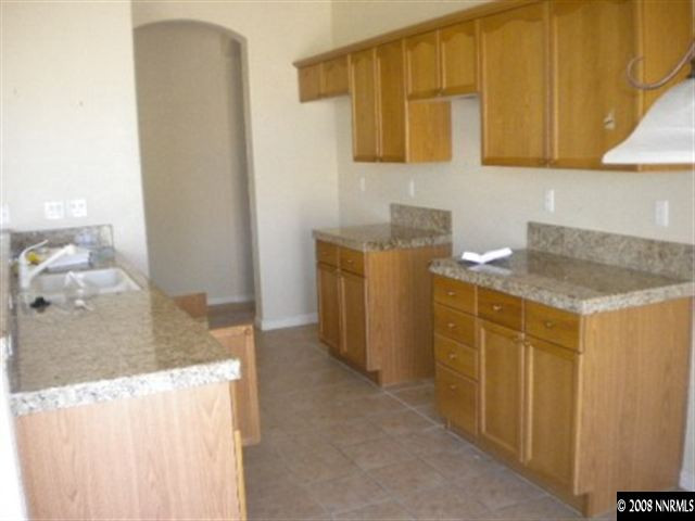 1607 Sewell Drive Reno, NV 89521 - Photo 4 of 8 a bathroom with a granite countertop sink and a mirror