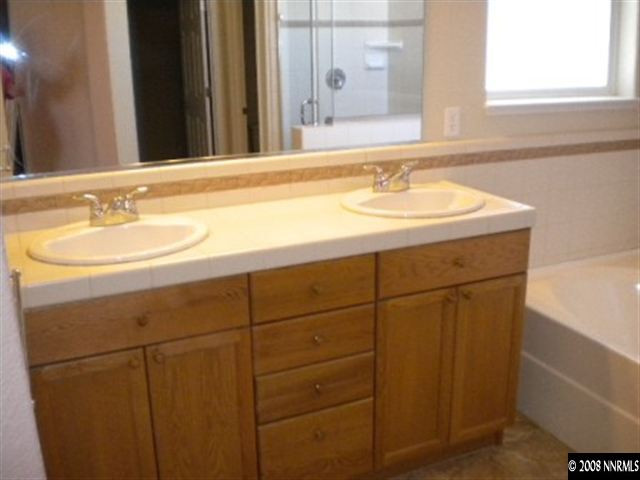 1607 Sewell Drive Reno, NV 89521 - Photo 5 of 8 a bathroom with a sink and a mirror