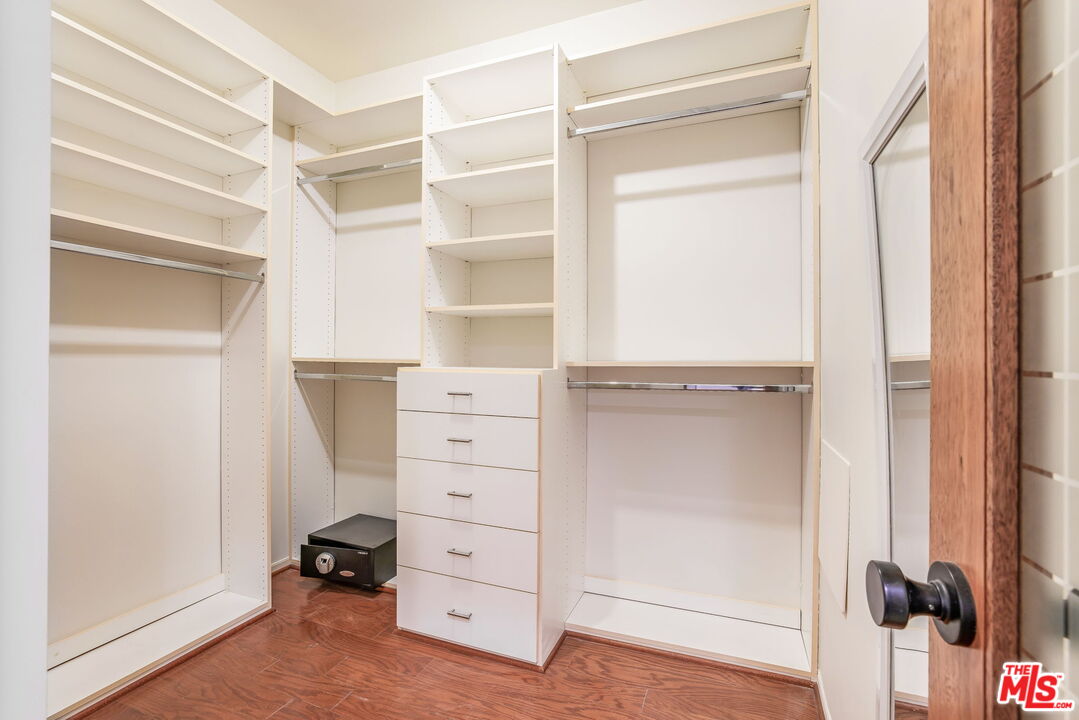11805 Mayfield Avenue, Unit 202 Los Angeles, CA 90049 - Photo 12 of 17 a view of walk in closet with clothes