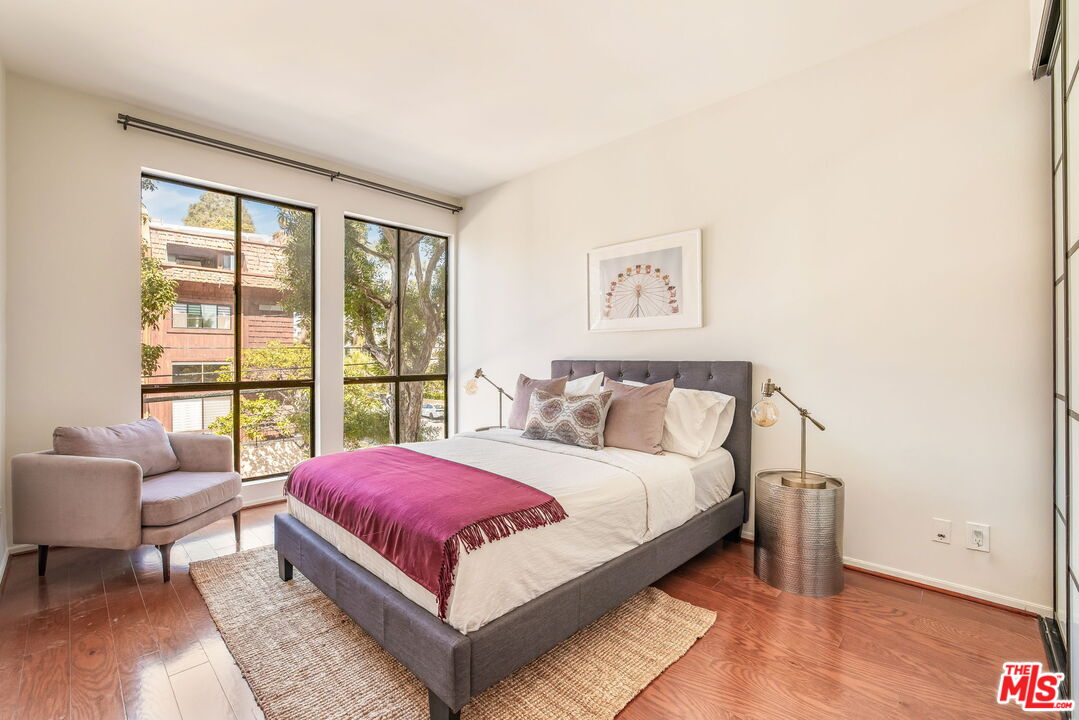 11805 Mayfield Avenue, Unit 202 Los Angeles, CA 90049 - Photo 14 of 17 a bedroom with a bed and a large window