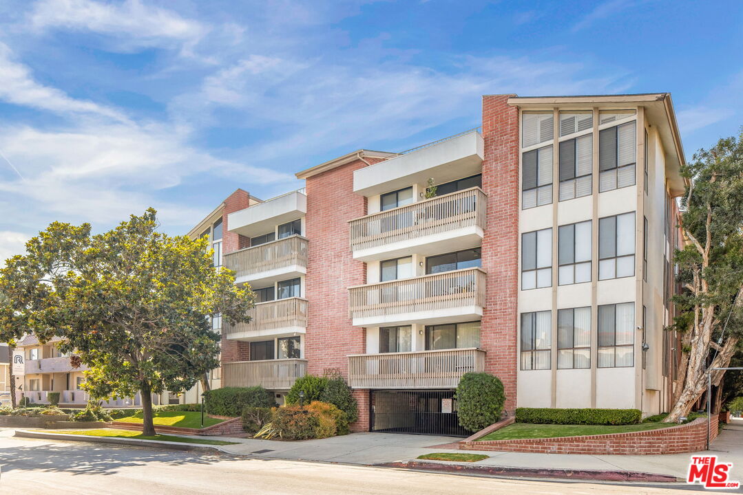 11805 Mayfield Avenue, Unit 202 Los Angeles, CA 90049 - Photo 17 of 17 a front view of a residential apartment building with a yard