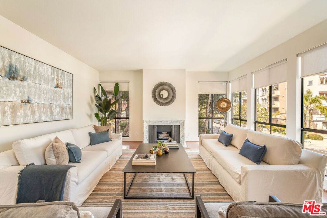 11805 Mayfield Avenue, Unit 202 Los Angeles, CA 90049 - Photo 2 of 17 a living room with furniture and a large window