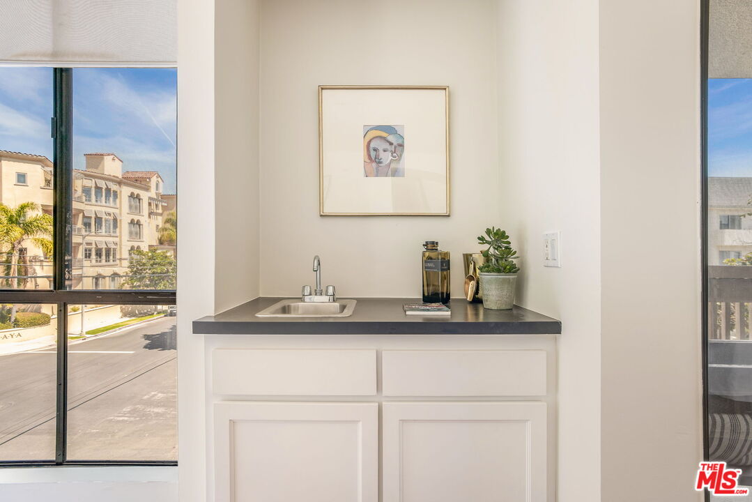 11805 Mayfield Avenue, Unit 202 Los Angeles, CA 90049 - Photo 3 of 17 a bathroom with a sink and a mirror