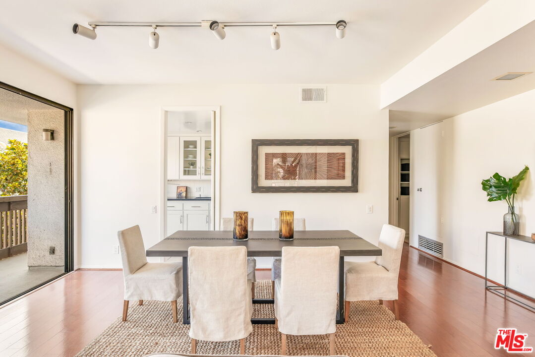 11805 Mayfield Avenue, Unit 202 Los Angeles, CA 90049 - Photo 4 of 17 a dining room with furniture and window