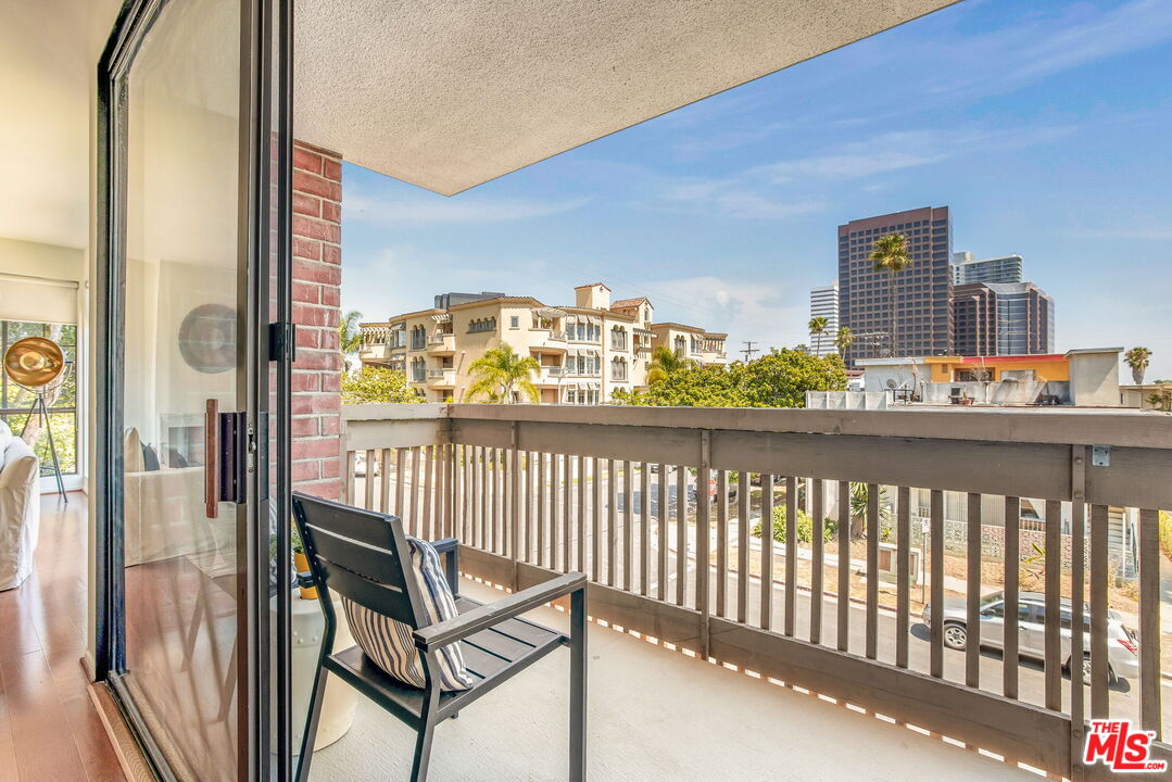 11805 Mayfield Avenue, Unit 202 Los Angeles, CA 90049 - Photo 5 of 17 a view of a balcony with furniture