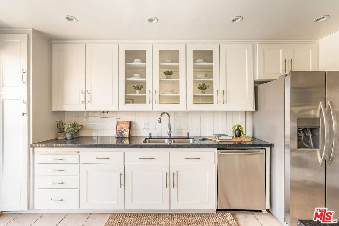 11805 Mayfield Avenue, Unit 202 Los Angeles, CA 90049 - Photo 6 of 17 a kitchen with granite countertop a sink stainless steel appliances and cabinets