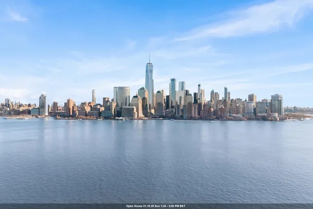 a kitchen with stainless steel appliances granite countertop a sink a stove and a wooden floors