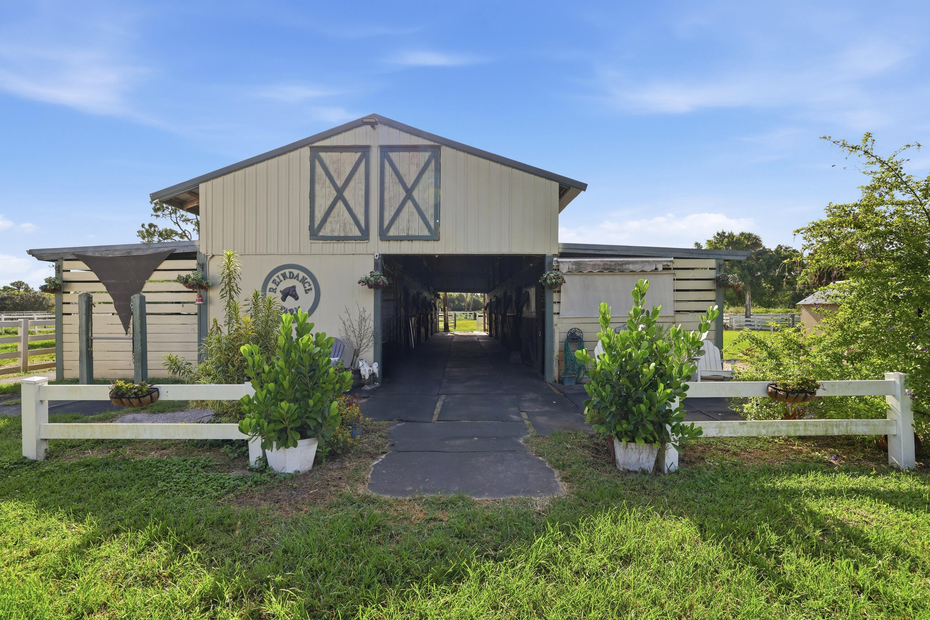 14095 Biddex Road Loxahatchee Groves, FL 33470 - Photo 36 of 69 a front view of a house with garden