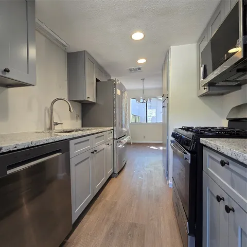 an empty room with wooden floor and fireplace