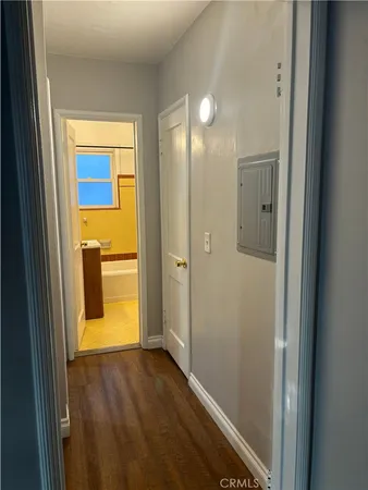 a view of empty room with wooden floor